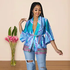 Detailed view of women's vibrant faux silk kimono top featuring floral and stripe patterns