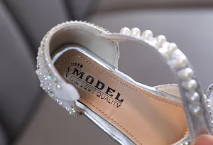 Detail of silver girls' princess shoe showing pearls, rhinestones, and high-quality insole.