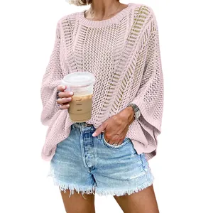 Close-up of pink oversized hollow-out crochet knit beach cover-up on a model