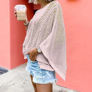 Close-up detail of a pink hollow-out knit beach cover-up featuring intricate mesh textures