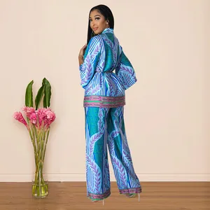 Detailed view of women's faux silk two-piece set featuring vibrant blue and green prints.