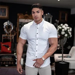 Close-up detail of a male model wearing a white muscle fit stretch short-sleeved shirt