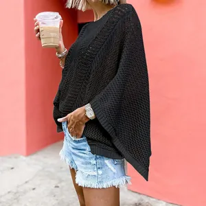 Detailed macro view of black crochet mesh knit beach cover-up poncho with a loose fit