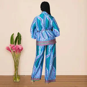 Back view of women's satin leaf print two-piece loungewear set with wide-leg pants