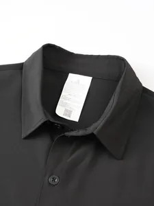 Close-up of black men's short-sleeve polo shirt collar and inner care label detail