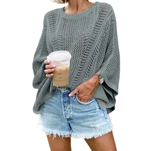 Close-up view of the grey mesh knit beach cover-up with delicate crochet pattern