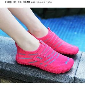 Close-up of pink breathable kids' water shoes with teal stripes and velcro strap