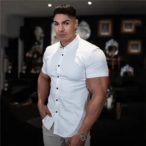 Macro detail view of a white muscle fit short sleeve shirt on a muscular male model.