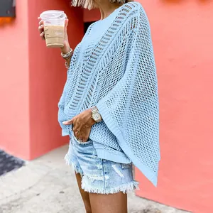 Detailed view of a light blue hollow-out mesh knit beach cover-up with oversized sleeves