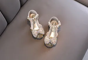Detailed view of girls princess shoes featuring sparkling rhinestones and pearl ankle straps