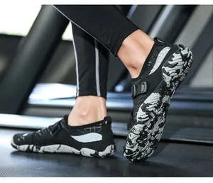 Close-up of black mesh wading shoes with camouflage soles on a treadmill