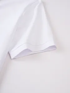 Close-up detail of white short sleeve shirt cuff with fine stitching and smooth fabric texture.