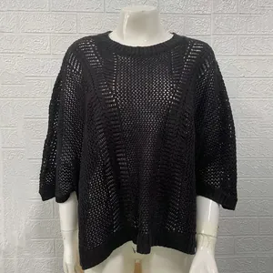 Detail of black crochet mesh knit cover-up with hollow-out pattern for beach vacation