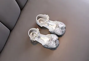 Elegant silver glittery girls princess shoes with sparkling bow tie and pearl strap details