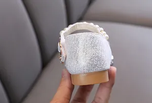 Detailed view of the silver glitter heel and pearl strap on girls princess shoes.