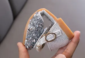Close-up of flexible silver sequined princess shoe for girls showing soft sole detail