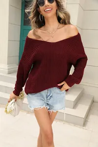 Close-up of wine red V-neck knit sweater with off-the-shoulder long sleeves design.