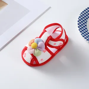 Soft-sole floral baby girl walking shoes featuring a colorful flower ornament and red trim