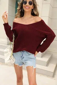 Detail showing a stylish women's burgundy V-neck long-sleeve knit sweater outfit