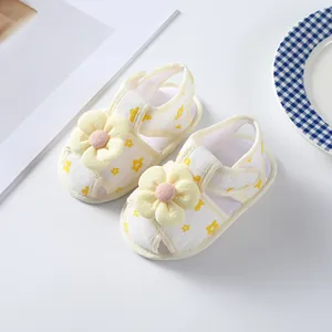 Detailed view of yellow floral baby girl sandals with 3D flower decoration and soft sole