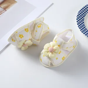 Detailed macro view of soft yellow flower ornament on breathable cotton baby girl sandals