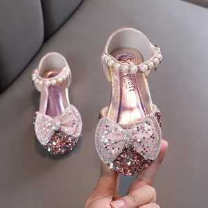 Elegant sparkly pink girls princess dress shoes with large glitter bow and pearl strap