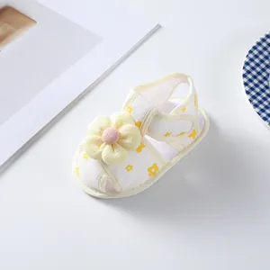 Close-up of baby girl summer sandal with 3D yellow flower and soft sole texture