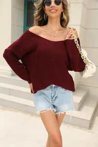 Detailed close-up of wine red V-neck knitted sweater with textured loose fit design