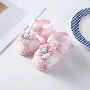 Close-up detail of pink floral baby girl walking sandals with soft fabric flower decor