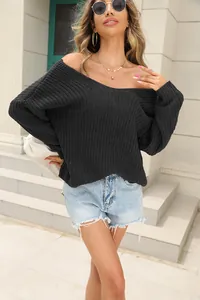 Close-up detail of a women's black oversized V-neck knitted sweater for autumn style