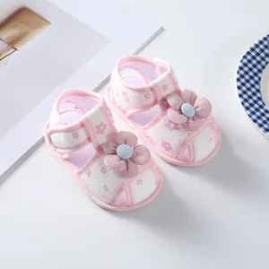 Close-up detail of pink floral baby girl walker shoes featuring soft soles and flower design