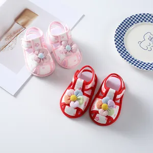 Detailed shot of pink and red floral baby girl walking shoes on white surface