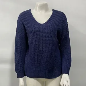 Detailed close-up of a blue V-neck knitted sweater with a textured waffle pattern
