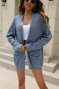 Detailed close-up showing the soft blue knit texture of a loose open cardigan