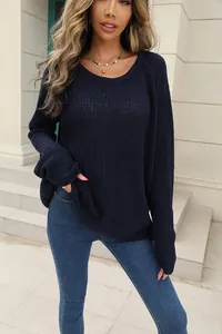 Close-up of a women's navy blue long sleeve knitted sweater with a relaxed fit.