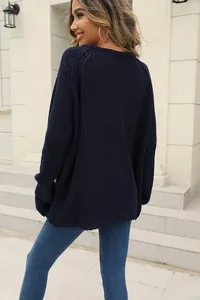 Detailed back view of a cozy navy blue chunky knit sweater for casual autumn style.