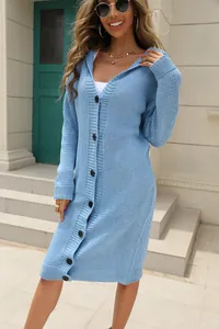 Close-up detail of a light blue long hooded knit cardigan with front black buttons.