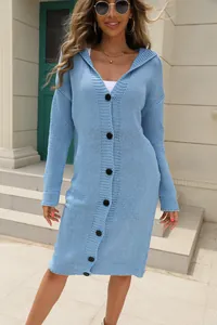 Detail view of a light blue long-line hooded cardigan with contrasting black buttons.