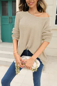 Detail view of the beige off-shoulder knit sweater texture and stylish sleeve design
