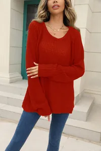 Detailed view of a vibrant red knit sweater showcasing soft texture and weave pattern