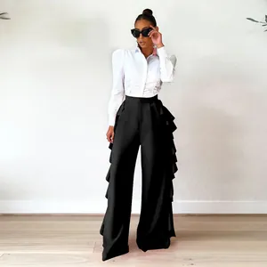 Elegantes pantalones negros de pierna ancha y cintura alta con volantes