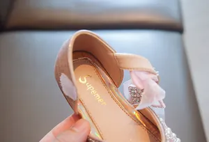 Nahaufnahme von rosa Prinzessinnenschuhen für Mädchen mit Perlenbogen-Detail