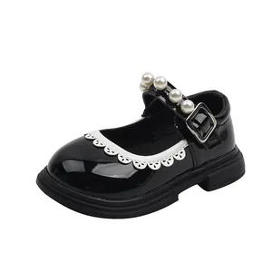 Black patent leather girl's Mary Jane shoes with pearl strap and lace trim