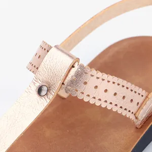Close-up view of stylish rose gold PU leather sandals featuring a laser-cut pattern