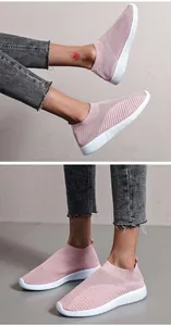 Womens pink breathable fly-knit slip-on sneakers with textured white flat soles