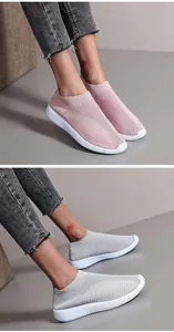 Detail view of breathable pink and grey mesh slip-on sneakers with textured white soles