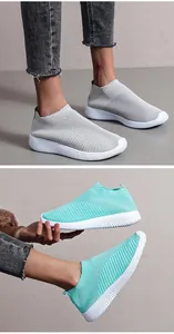 Detailed side view of breathable light blue and grey knitted slip-on sneakers for women