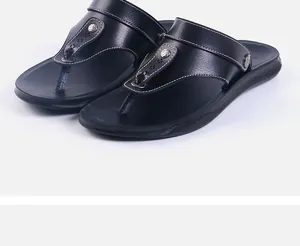Detailed view of black leather men's flip-flops with stylish metal rivet accents