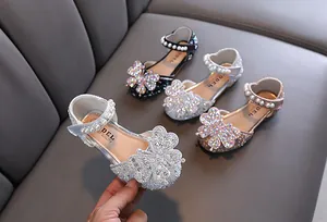 Close-up of girls' princess shoes featuring rhinestone butterfly and pearl strap design