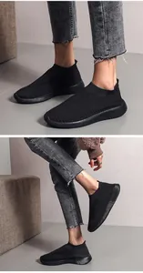 Detailed view of black breathable fly-knit sneakers featuring a comfortable slip-on design